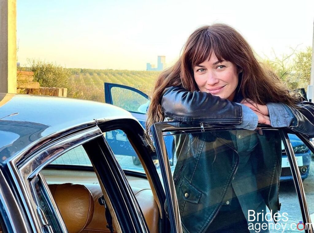Olga Kurylenko near the car