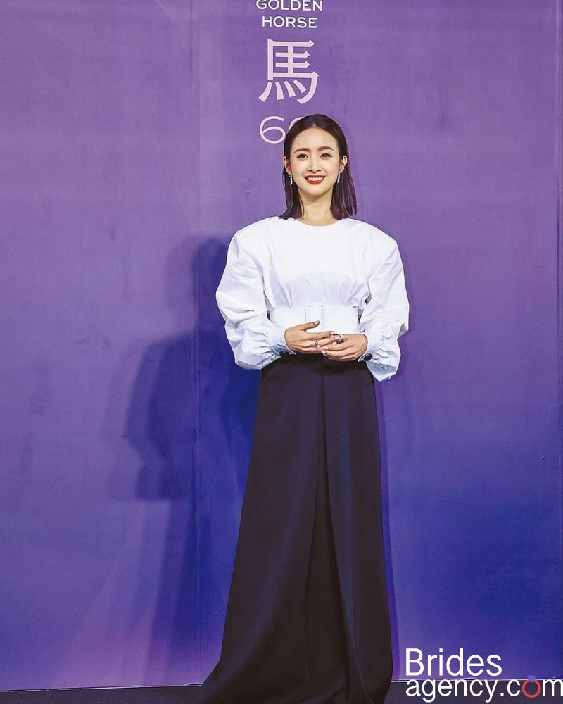 Ariel Lin in a black skirt and a white shirt